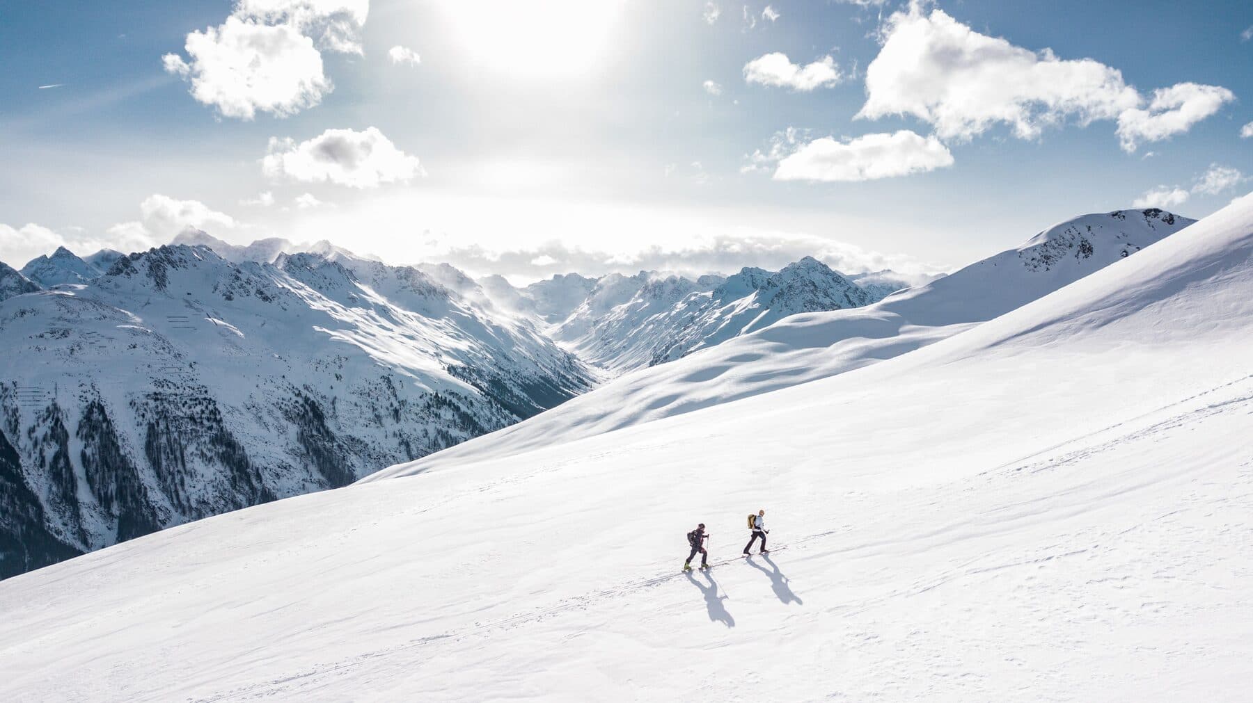 Two ski tourers in alpine mountain landscape